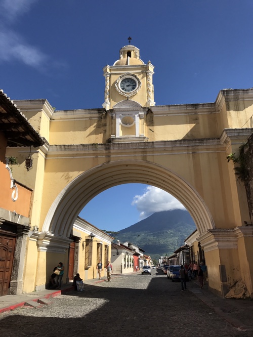 The iconic arch in Antigua, Guatemala. Behind it is Volcano Agua.